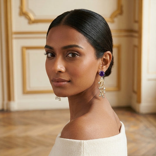 Model wearing the Météore Drop Earrings, gold-tone brass, simulated amethysts, simulated diamonds