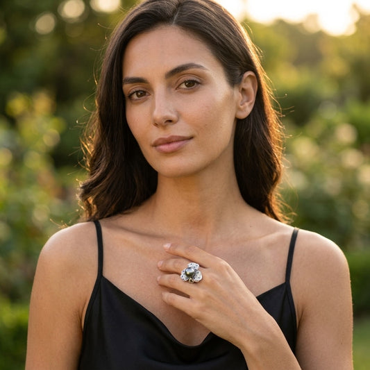 Model wearing the Orchidée Ring, silver-tone brass, simulated grey pearl, simulated sapphires, simulated emeralds, simulated diamonds
