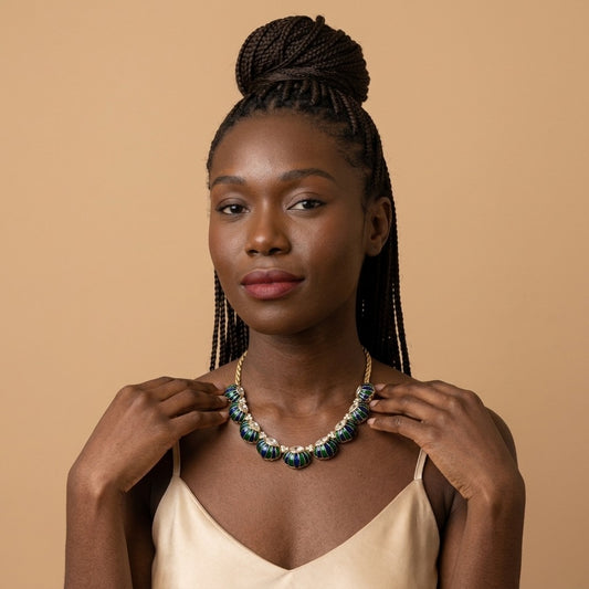 Model wearing the Paon Necklace, gold-tone brass, blue and green enamel, simulated diamonds