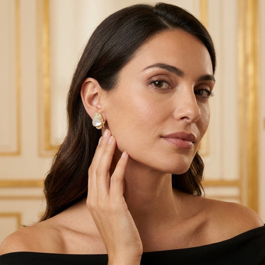 Model wearing the Papillon Stud Earrings, gold-tone brass, pearlescent inlay, simulated diamonds