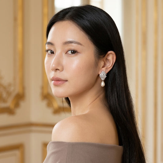 Model wearing the Volute Drop Earrings, silver-tone brass, simulated pearls, simulated diamonds