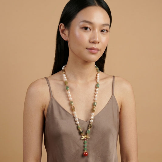 Model wearing the Abeille Necklace, cultured freshwater pearls, gold-tone sterling silver, colored beads