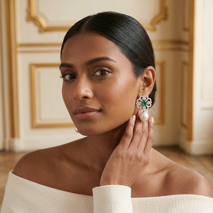 Model wearing the Arabesque Drop Earrings, silver-tone brass, simulated emeralds, simulated pearls, simulated diamonds
