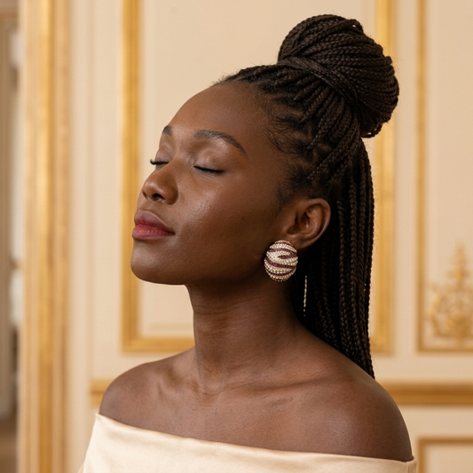 Model wearing the Bombé Earrings, gold-tone brass, fuchsia and clear simulated stones