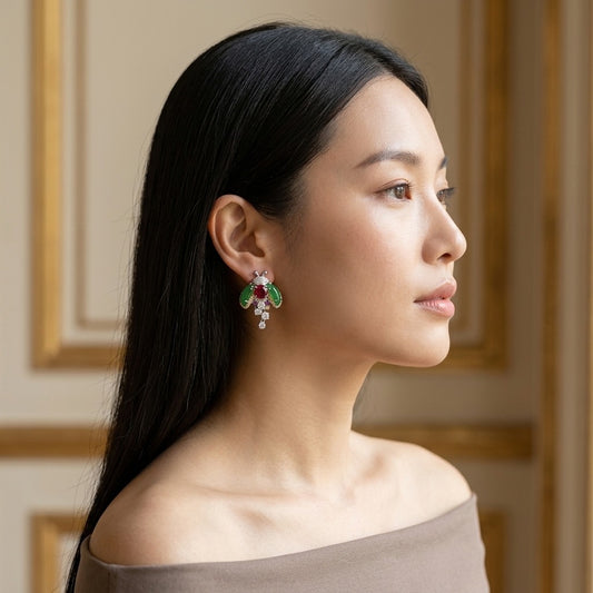 Model wearing the Coccinelle Drop Earrings, silver-tone brass, simulated jade, simulated rubies, simulated diamonds