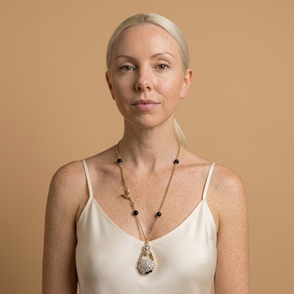 Model wearing the Colibri Necklace, gold-tone brass, black beads, simulated diamonds