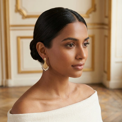Model wearing the Coquille Drop Earrings, gold-tone brass, white enamel, simulated diamonds