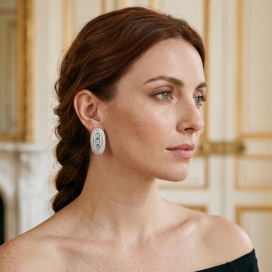 Model wearing the Deco Huggie Earrings, silver-tone brass, mint baguette stones, simulated diamonds