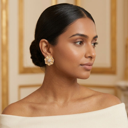 Model wearing the Marguerite Stud Earrings, gold-tone brass, frosted champagne petals, simulated diamonds