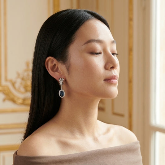 Model wearing the Odéon Drop Earrings, silver-tone brass, simulated sapphires, simulated diamonds