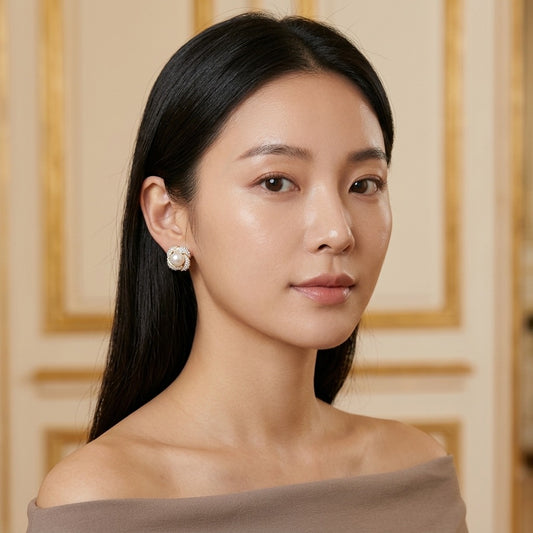 Model wearing the Tourbillon Stud Earrings, two-tone brass, simulated pearls, simulated diamonds