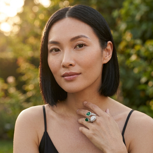 Model wearing the Vague Open Ring, silver-tone brass, simulated emeralds, simulated diamonds