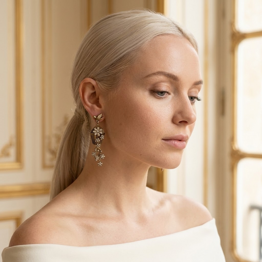 Model wearing the Volière Drop Earrings, antique gold-tone brass, simulated diamonds